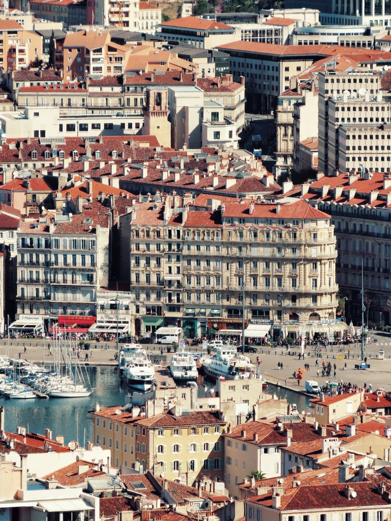 Explore the vibrant Old Port of Marseille from above, showcasing bustling harbor life and historic architecture.